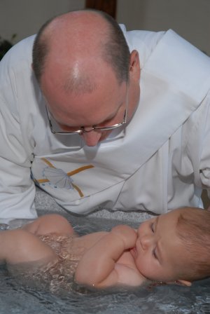 Deacon John baptizing an infant.